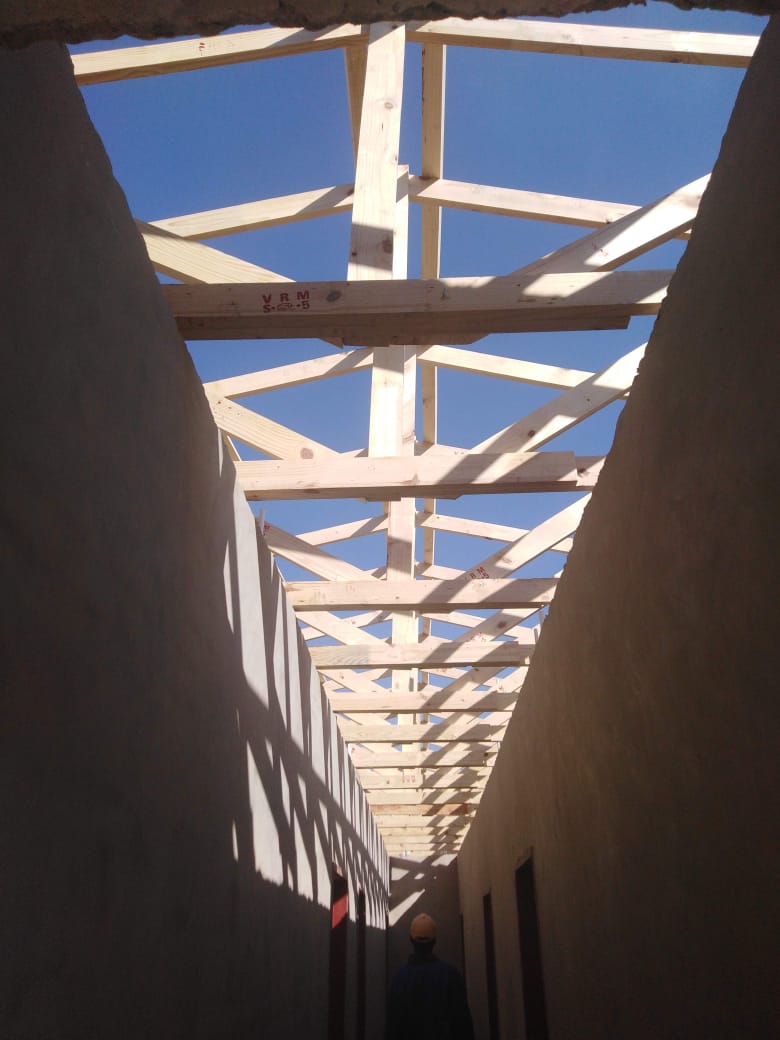 Timber roof truss structure viewed from inside an unfinished building